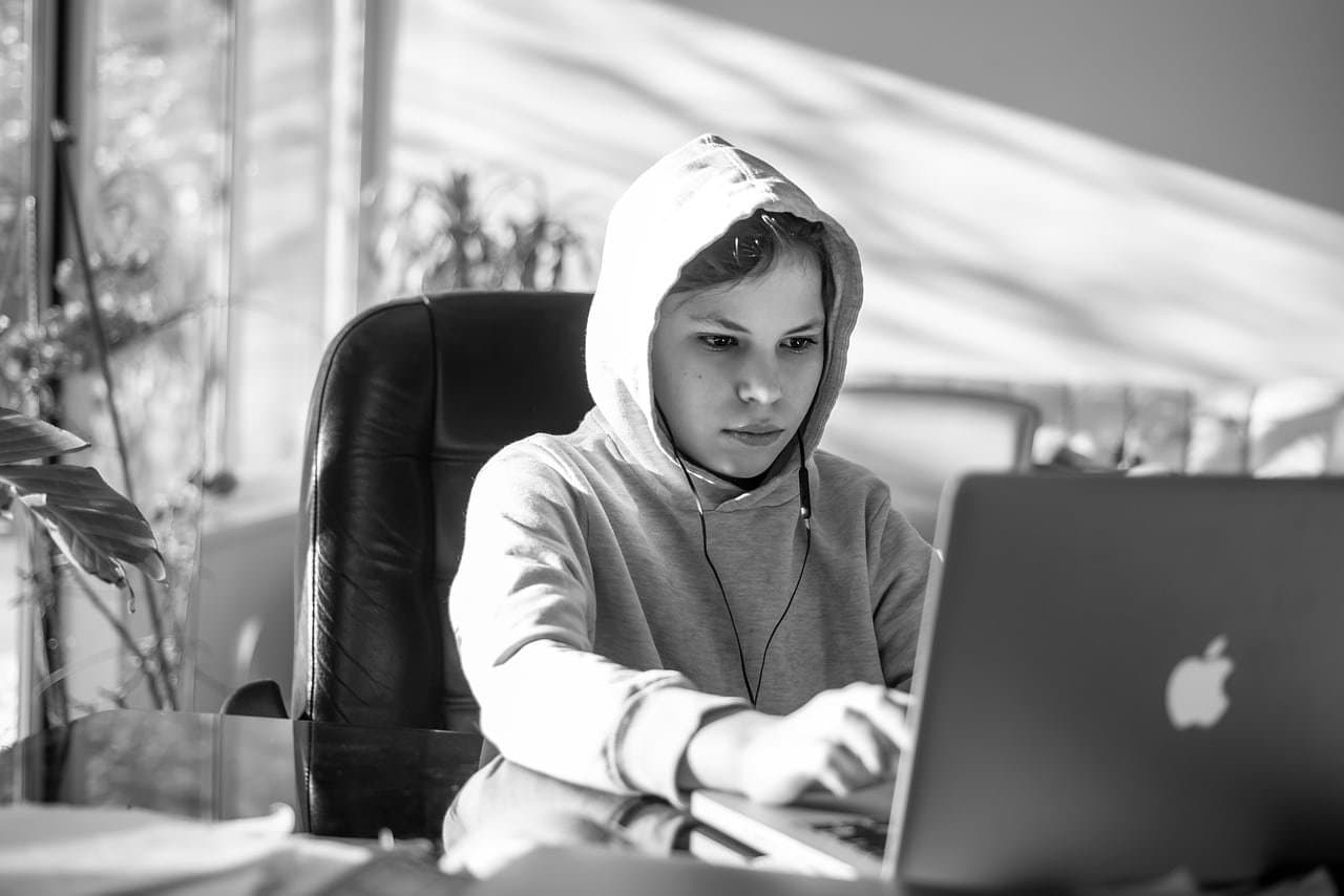 Adult student studying with a notebook and laptop